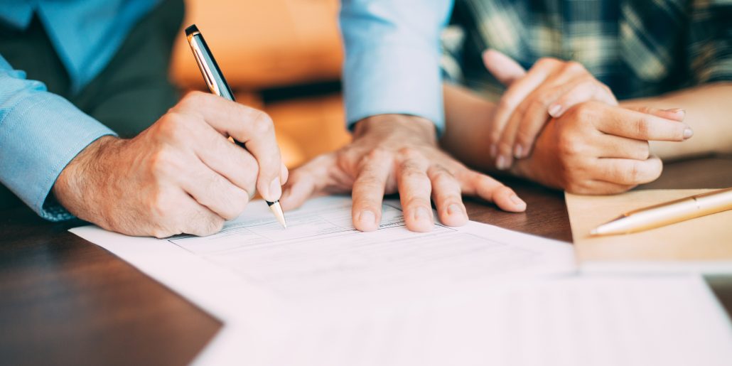 Senior candidate filling application form at table